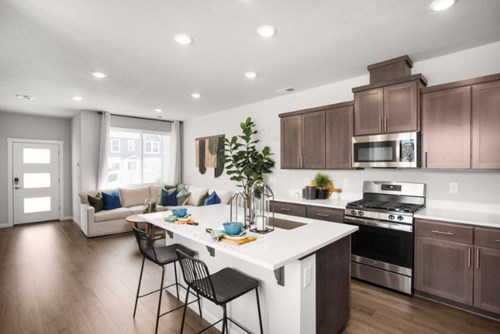 An open plan kitchen in a model home for sale from Lennar at Reed’s Crossing.