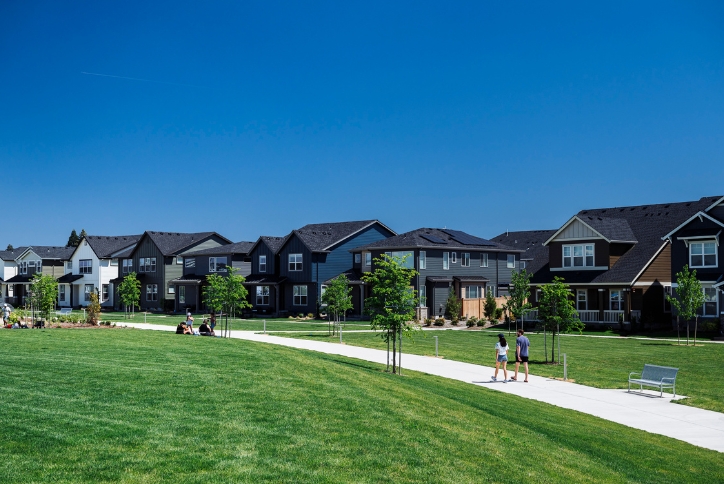 People walk along a path in Reed’s Crossing Park on a sunny day in Hillsboro, Oregon.