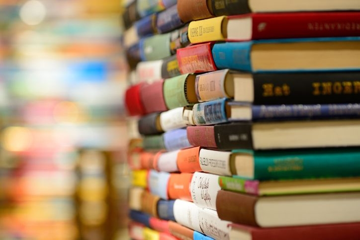 Close-up of stacks of colorful hardcover books.