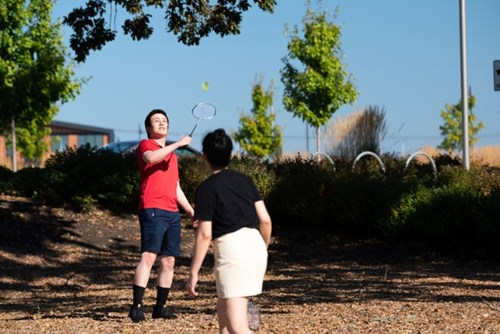 A man and a woman play badminton in Hillsboro’s Oak Grove Park.