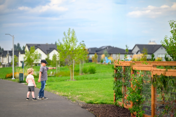 Two young boys point at something they see while exploring walking paths in Reed’s Crossing.