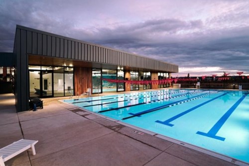 Active Wellness Center’s outdoor pool in Reed’s Crossing glows at dusk.