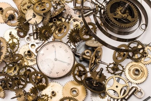 A clock surrounded by brass gears in a steampunk setting.